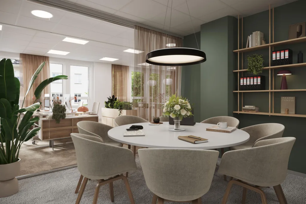 2. Ett mötesrum med ett runt bord, sex stolar och en modern lampa ovanför.