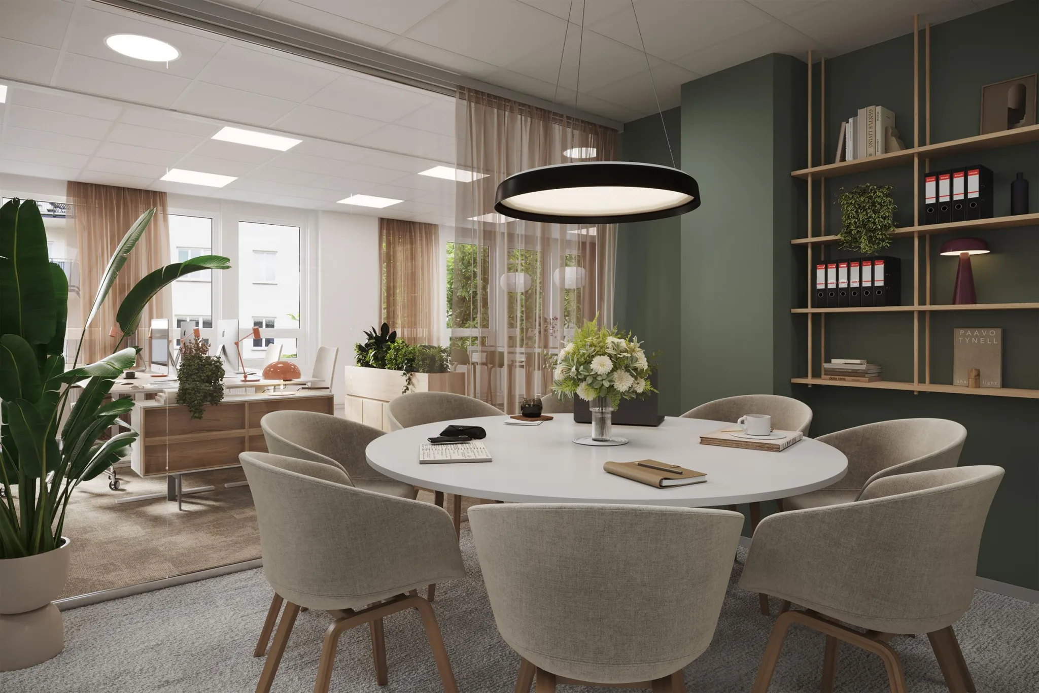 5. Ett mötesrum med ett runt bord, bekväma stolar och en modern lampa ovanför.