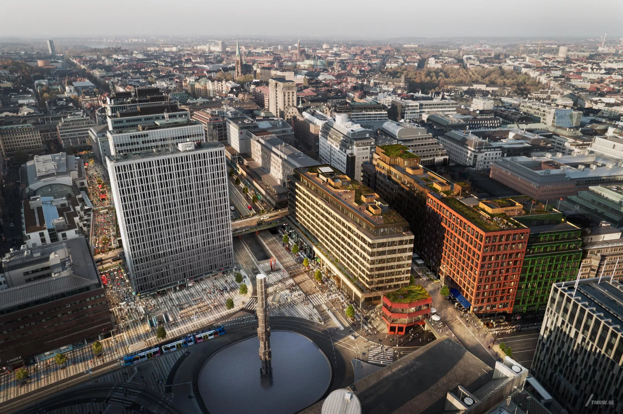 Fågelperspektiv över stadsmiljö med moderna byggnader och ett cirkelformat torg.
