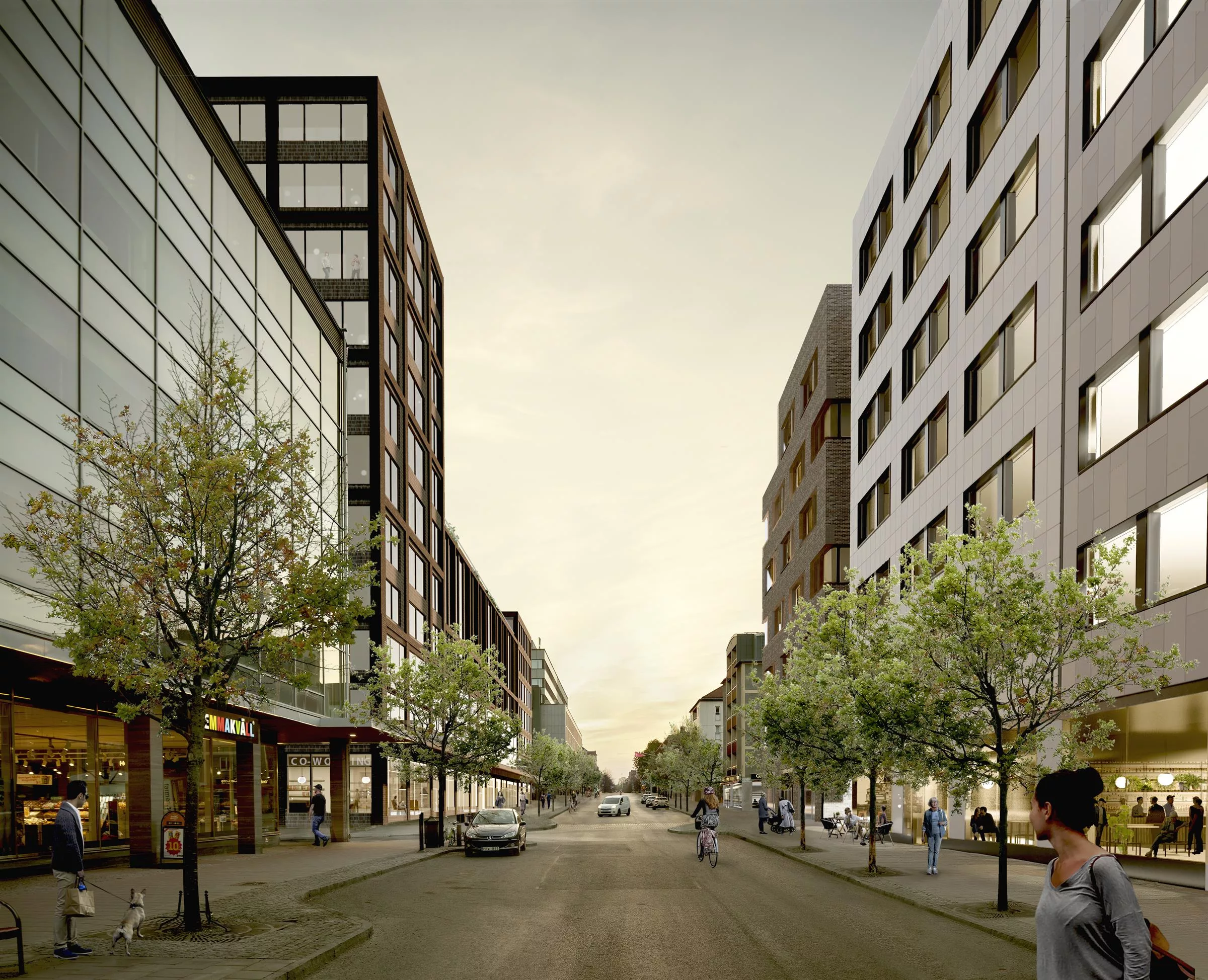 2. En stadsgata kantad av moderna byggnader och träd med gångare och bilar längs gatan.
