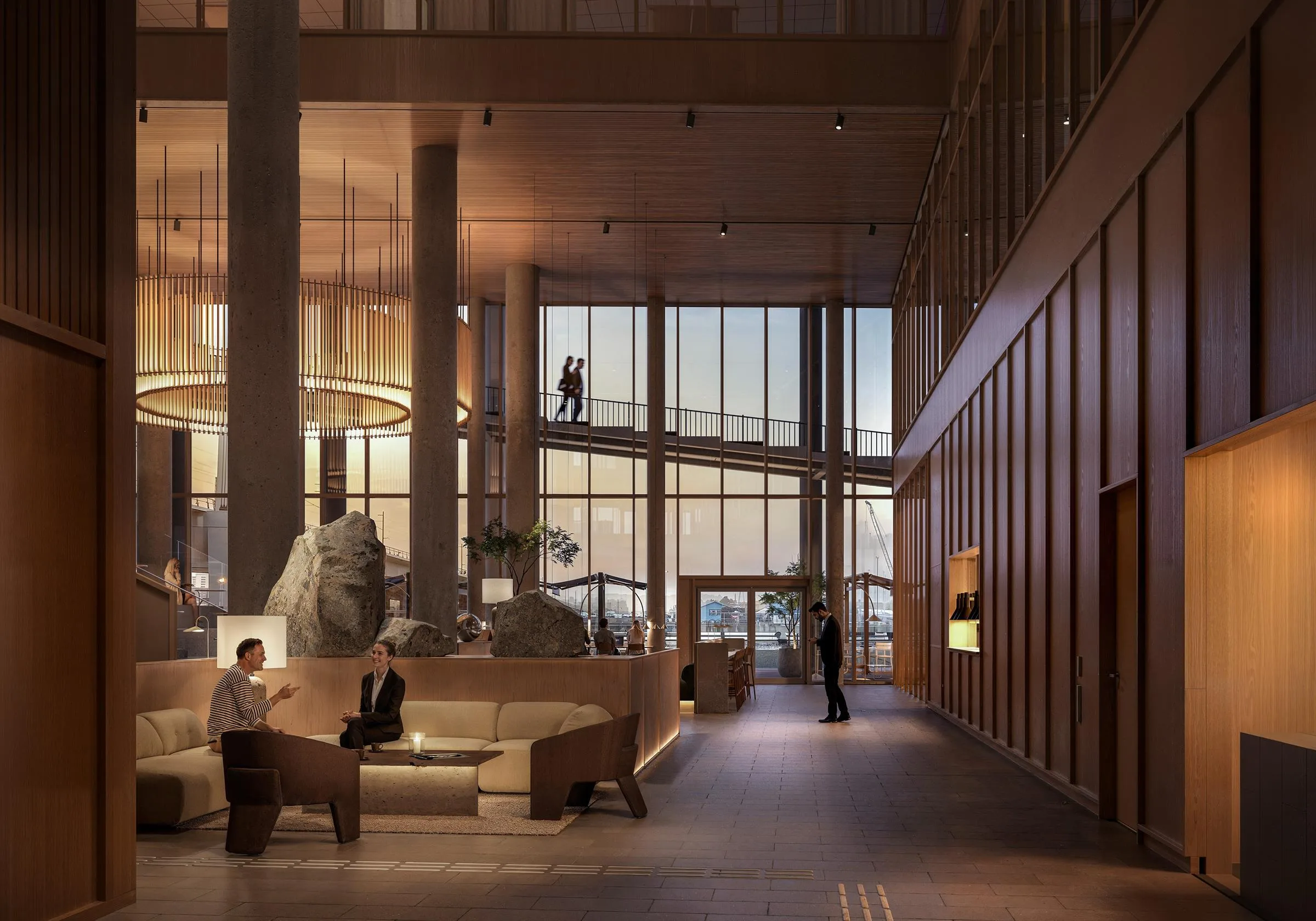 3. Elegant hotellobby med stora glasväggar, sittgrupper och mjuk belysning.