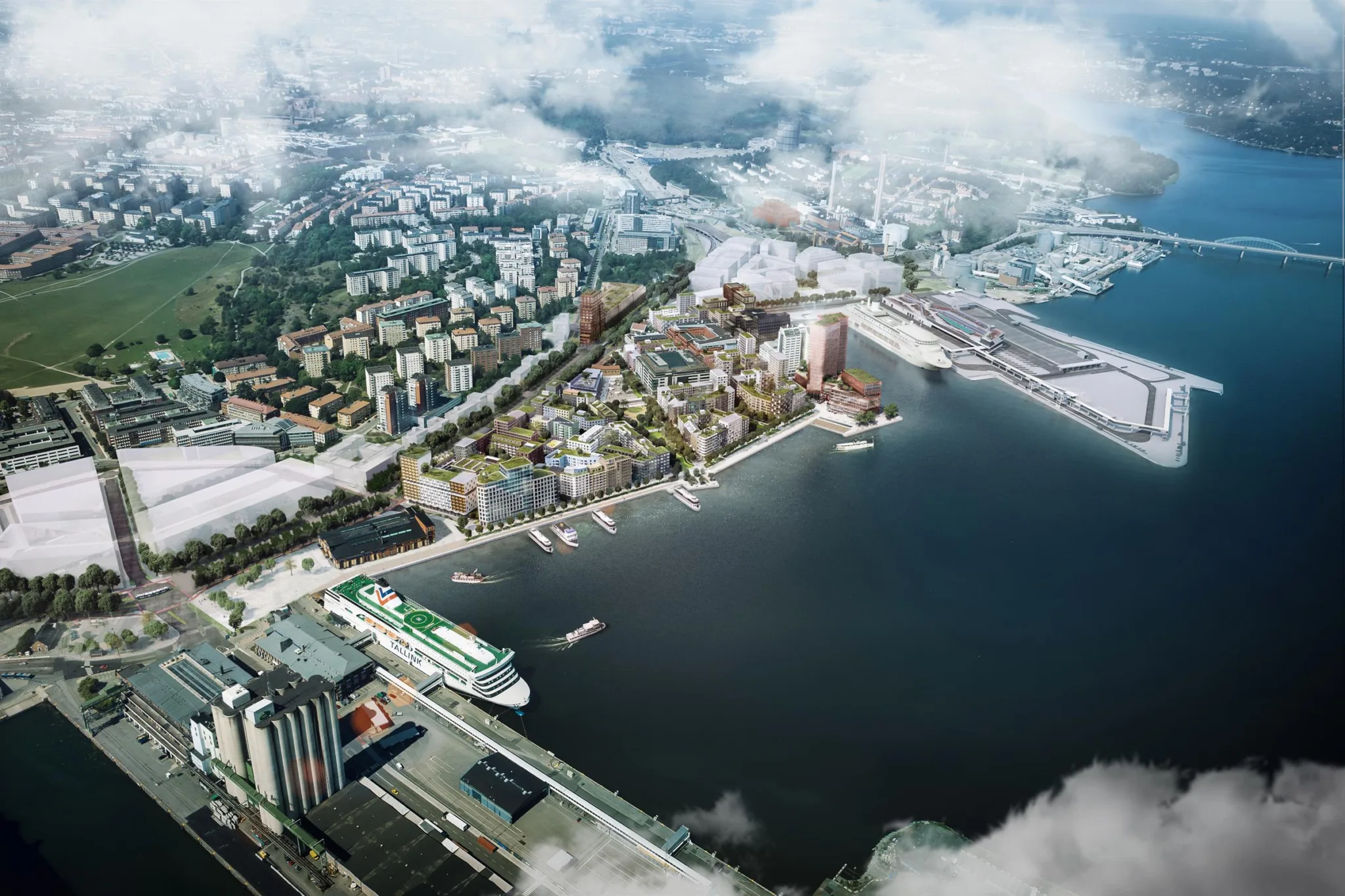 4. En flygvy över en kuststad med byggnader, hamn och vatten omgiven av moln.