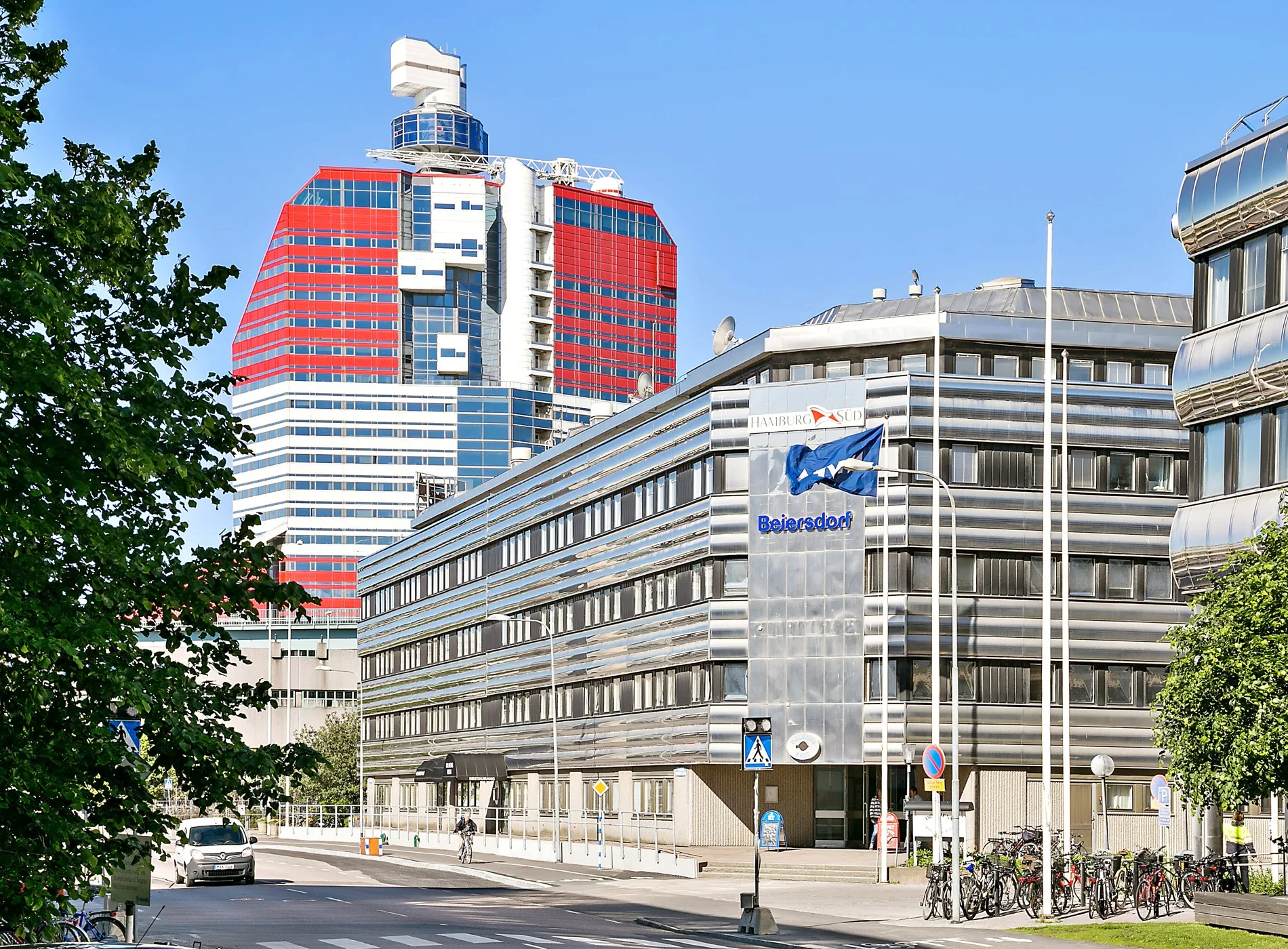 5. En byggnad med blå flagga och texten "Göteborgs Hamn", med en röd och vit skyskrapa i bakgrunden.